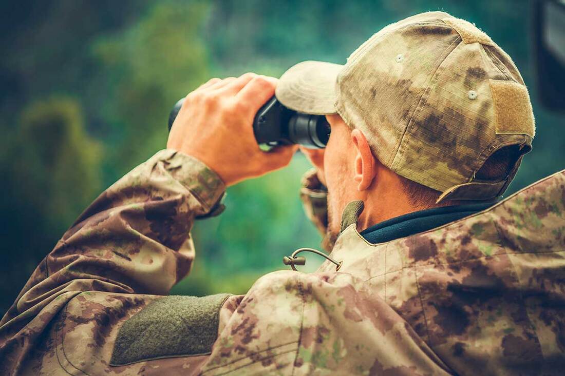 Arkansas Hunter looking through binoculars
